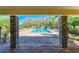 Community pool area framed by stone pillars, offering a refreshing retreat with ample lounge chairs at 2084 La Palma Ave, Port Charlotte, FL 33953