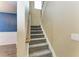 Carpeted staircase with white risers, wooden handrail and blue accent wall at 2084 La Palma Ave, Port Charlotte, FL 33953