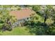 Aerial view of house with lush yard, screened-in patio, and tile roof at 2115 Timucua Trl, Nokomis, FL 34275