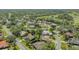 Beautiful aerial view of a residential neighborhood close to a golf course and mature trees at 2115 Timucua Trl, Nokomis, FL 34275