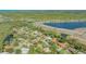 Sprawling aerial view of a neighborhood with single Gathering homes, ponds, water features and mature landscaping at 2115 Timucua Trl, Nokomis, FL 34275