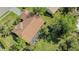 Aerial view of home with lush yard, mature trees, screened-in patio, and tile roof at 2115 Timucua Trl, Nokomis, FL 34275
