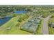 Aerial view of the golf course, tennis courts and community amidst a lush green landscape at 2115 Timucua Trl, Nokomis, FL 34275