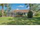 View of the home's lovely, expansive lawn and private screened-in patio at 2115 Timucua Trl, Nokomis, FL 34275