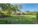 Lush green yard with mature trees and landscaping at 2115 Timucua Trl, Nokomis, FL 34275