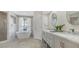 Elegant bathroom featuring a soaking tub, double vanities, modern fixtures, and a separate glass shower at 2115 Timucua Trl, Nokomis, FL 34275