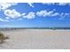 A pristine white-sand beach offers a tranquil space for relaxation and recreation at 2115 Timucua Trl, Nokomis, FL 34275