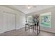 Spacious bedroom with vaulted ceiling, built-in desk area, and large windows showcasing the yard at 2115 Timucua Trl, Nokomis, FL 34275