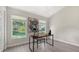 Bright bedroom with vaulted ceiling, built-in desk area, and large windows showcasing lush landscaping at 2115 Timucua Trl, Nokomis, FL 34275
