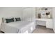 Bright bedroom featuring wood floors and built-in desk with shelves for storage at 2115 Timucua Trl, Nokomis, FL 34275
