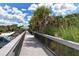Scenic boardwalk leading to the beach, offering accessible enjoyment of the outdoors at 2115 Timucua Trl, Nokomis, FL 34275