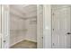Walk in closet with built-in wire shelving and door to additional storage space in this modern home at 2115 Timucua Trl, Nokomis, FL 34275