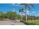 Gated community entrance with lush landscaping, golf course, tennis courts and course maintenance at 2115 Timucua Trl, Nokomis, FL 34275