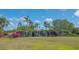 Scenic community waterfall with lush landscaping and tropical plants under a clear blue sky at 2115 Timucua Trl, Nokomis, FL 34275
