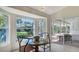 Bright dining area with a bay window, chandelier, and access to the lanai at 2115 Timucua Trl, Nokomis, FL 34275