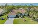 Stunning home with red tile roof, lush landscaping, and a well-maintained lawn at 2115 Timucua Trl, Nokomis, FL 34275