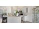 Modern kitchen with white cabinets, stainless steel appliances, and a breakfast bar at 2115 Timucua Trl, Nokomis, FL 34275