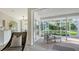 Screened lanai featuring comfortable seating and views of the lush, landscaped backyard at 2115 Timucua Trl, Nokomis, FL 34275
