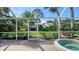 Covered outdoor patio offers a beautiful view of the backyard and garden at 2115 Timucua Trl, Nokomis, FL 34275