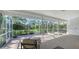 Enclosed lanai with lounge chairs and access to the spa, surrounded by greenery at 2115 Timucua Trl, Nokomis, FL 34275