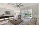 Bright living room with tile floors, neutral decor, and sliding glass doors to the outdoor space at 2115 Timucua Trl, Nokomis, FL 34275