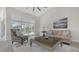 Bright living room with tile floors, neutral decor, and sliding glass doors to the outdoor space at 2115 Timucua Trl, Nokomis, FL 34275