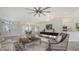 Open-concept living area with a ceiling fan, tiled floors, and natural light at 2115 Timucua Trl, Nokomis, FL 34275