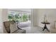 Sunlit living room featuring tile floors, stylish furniture, and sliding glass doors to an enclosed lanai at 2115 Timucua Trl, Nokomis, FL 34275