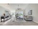 Bright living room with tile floors, neutral decor, and sliding glass doors to the outdoor space at 2115 Timucua Trl, Nokomis, FL 34275