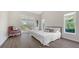 Light and airy main bedroom with an ensuite bath, a sliding glass door, and beautiful wood flooring at 2115 Timucua Trl, Nokomis, FL 34275