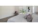 Spacious main bedroom with a large window providing natural light and views of the beautiful backyard at 2115 Timucua Trl, Nokomis, FL 34275