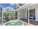 Screened-in patio with a relaxing hot tub and seamless access to the interior at 2115 Timucua Trl, Nokomis, FL 34275