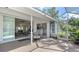 Enclosed patio with seating, seamlessly blending indoor and outdoor living spaces at 2115 Timucua Trl, Nokomis, FL 34275