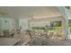 Covered pool patio with tables and chairs for entertaining and relaxing by the pool at 2115 Timucua Trl, Nokomis, FL 34275