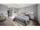 Serene main bedroom with tufted headboard, soft blue bedding, and elegant bedside tables and lamps at 21467 Dobbins Ave, Port Charlotte, FL 33954