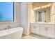Bathroom featuring double vanity, marble countertops, modern fixtures, and a standalone tub at 22 Medalist Cir, Rotonda West, FL 33947