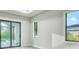 Bright bedroom with a view of the pool through sliding glass doors and natural light at 22 Medalist Cir, Rotonda West, FL 33947