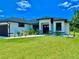 This well-maintained home has a pristine lawn, modern design, and a welcoming front entrance at 22 Medalist Cir, Rotonda West, FL 33947
