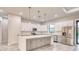 Modern kitchen features white cabinets, marble countertops, stainless appliances, and a central island at 22 Medalist Cir, Rotonda West, FL 33947