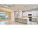 A modern kitchen with gray cabinets, marble countertops, and stainless appliances offers ample space for cooking at 22 Medalist Cir, Rotonda West, FL 33947