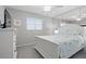 Inviting bedroom with neutral tones, ceiling fan, large window, and ample closet space at 2220 Stickney Point Rd # 531, Sarasota, FL 34231