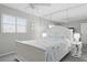 Comfortable bedroom featuring a large window, ceiling fan, and full-length mirror at 2220 Stickney Point Rd # 531, Sarasota, FL 34231