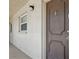 Exterior shot of unit 531 featuring a secure, modern door, bright window, and smooth walkway at 2220 Stickney Point Rd # 531, Sarasota, FL 34231