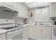 Spotless kitchen with white appliances, plenty of counter space, and nautical décor above sink at 2220 Stickney Point Rd # 531, Sarasota, FL 34231