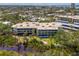 Spacious condo complex surrounded by lush trees, a lake and meticulously maintained grounds at 225 Hourglass Way # 101, Sarasota, FL 34242