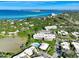 Stunning aerial view of the coastal community with lush greenery, waterfront access, and brilliant blue skies at 225 Hourglass Way # 101, Sarasota, FL 34242