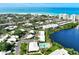 An aerial view showcases the community and private beach at 225 Hourglass Way # 101, Sarasota, FL 34242