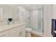 The bathroom boasts a glass-enclosed shower and stylish vanity with elegant fixtures and hardware at 225 Hourglass Way # 101, Sarasota, FL 34242