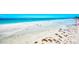 Expansive views of the community's private beach and crystal clear water at 225 Hourglass Way # 101, Sarasota, FL 34242