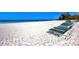 Private community beach with white sand and a row of beach chairs at 225 Hourglass Way # 101, Sarasota, FL 34242